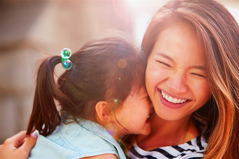 A woman and young child embracing each other