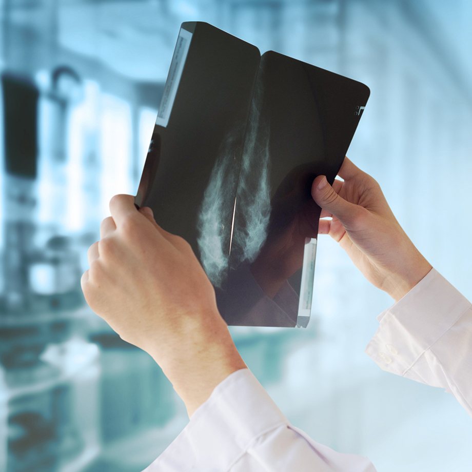 Health care professional reviewing an x-ray