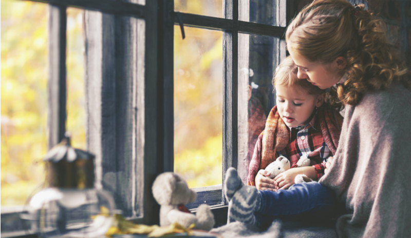 A woman snuggling with a child