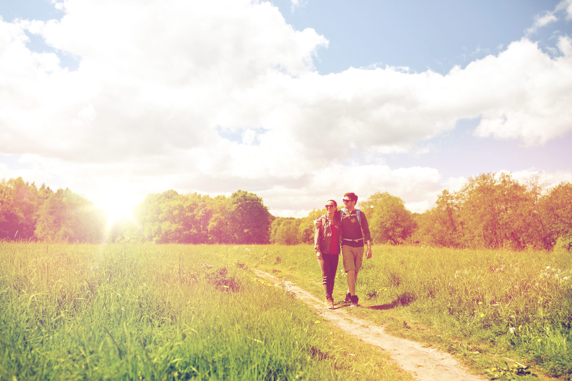 A couple walking through a field