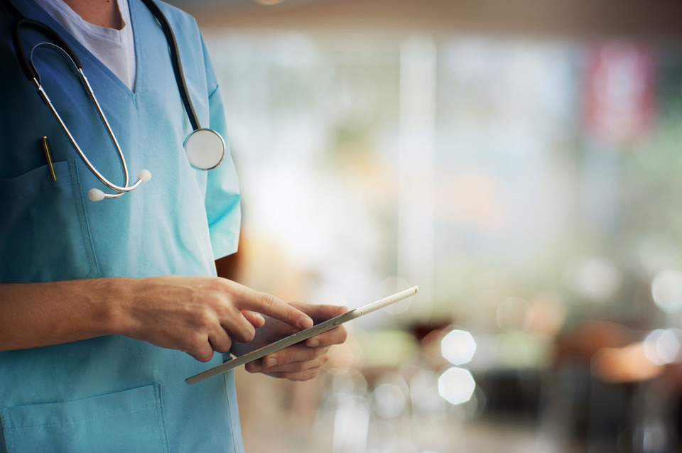 A physician using a tablet