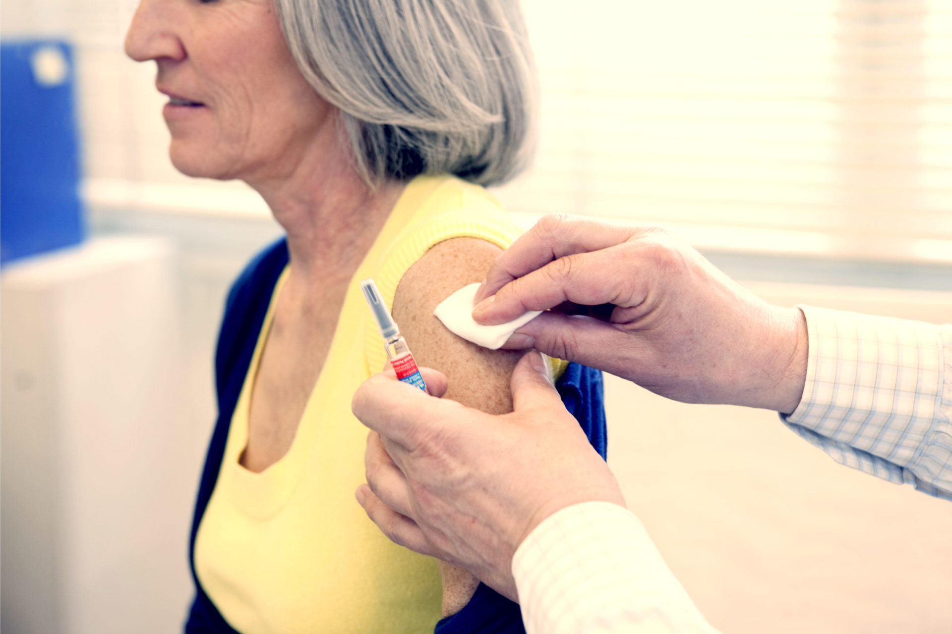 A woman getting vaccine shot in her arm