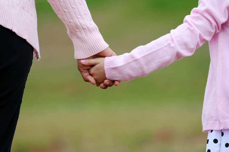 Mom and daughter holding hands