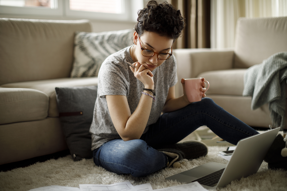 A student goes over homework while holding a cup of coffee