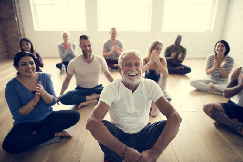 A diverse group of people in a yoga class