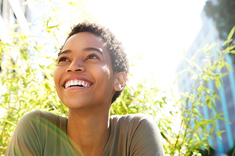 Young woman smiling outside