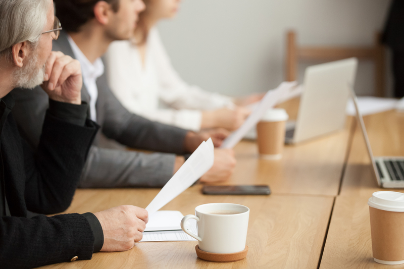 A group of individuals listen in on a meeting