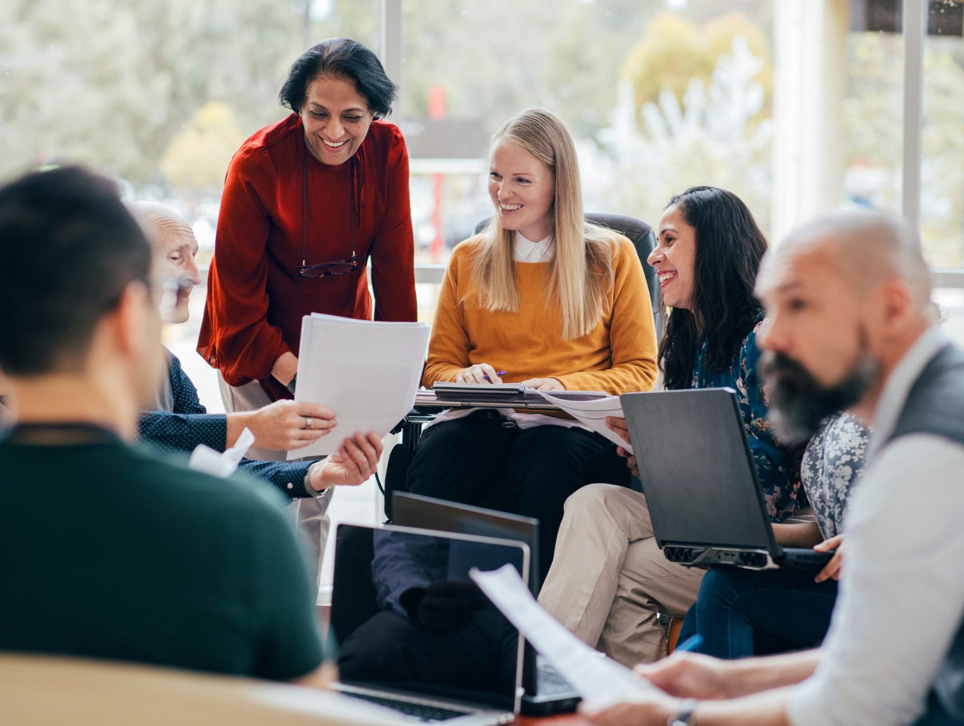 A group of people sharing notes in an office meeting