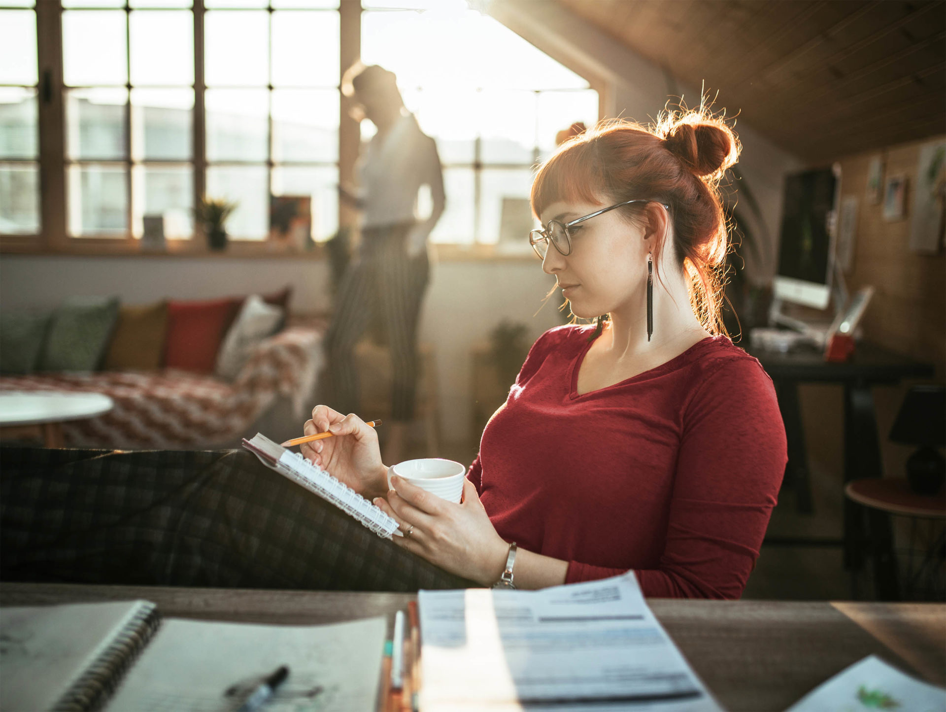 Two female coworkers working in a relaxed office setting