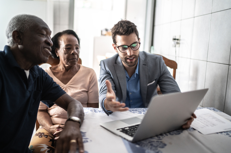 A senior couple having a meeting with a consultant at their home