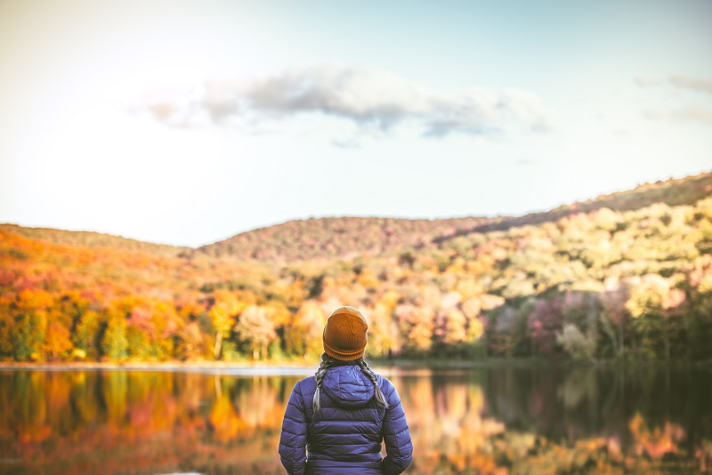 A woman looking at a beautiful autumn landscape