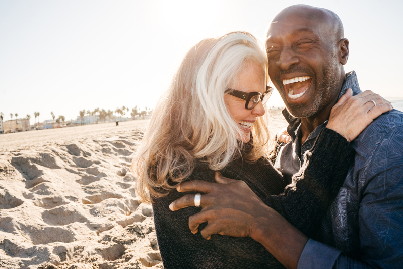 A senior couple embracing each other while laughing