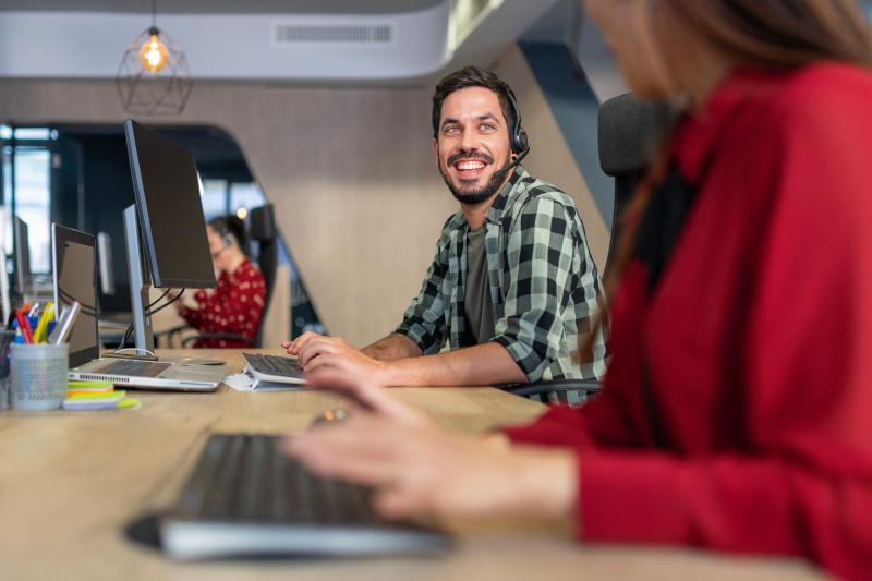 Two customer service representatives talking to each other