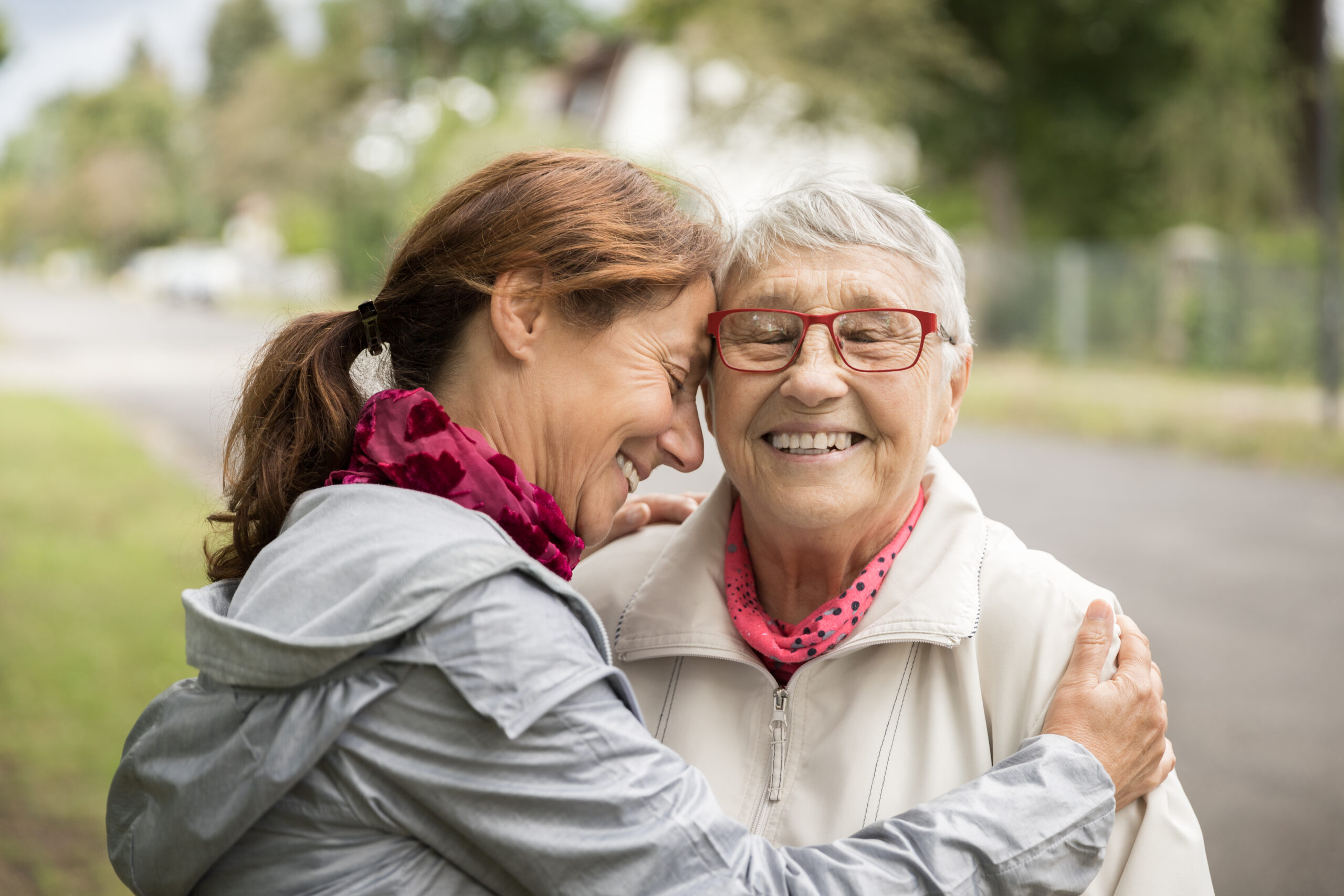 A woman embraces an elderly woman