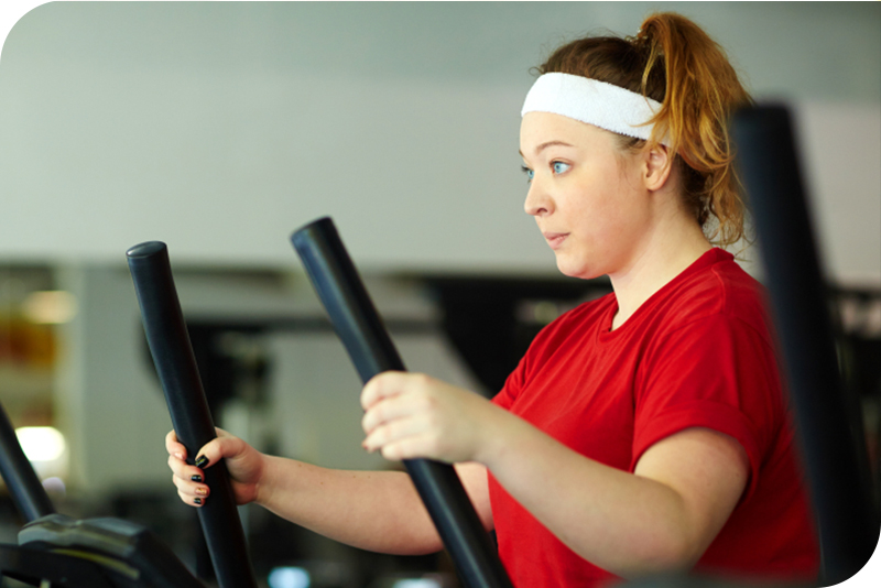 A woman exercising on an elliptical