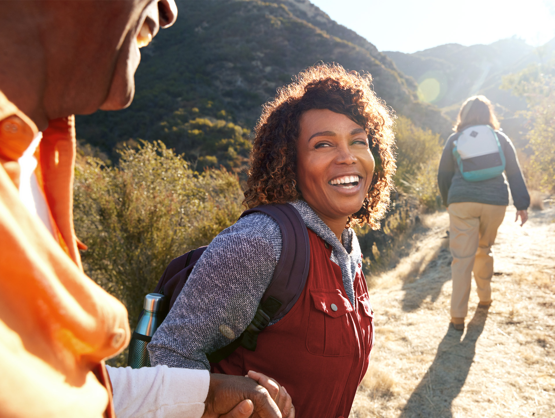 Three people hiking on a path