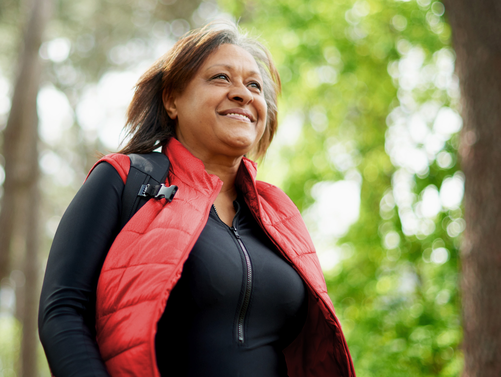 A woman smiling outside