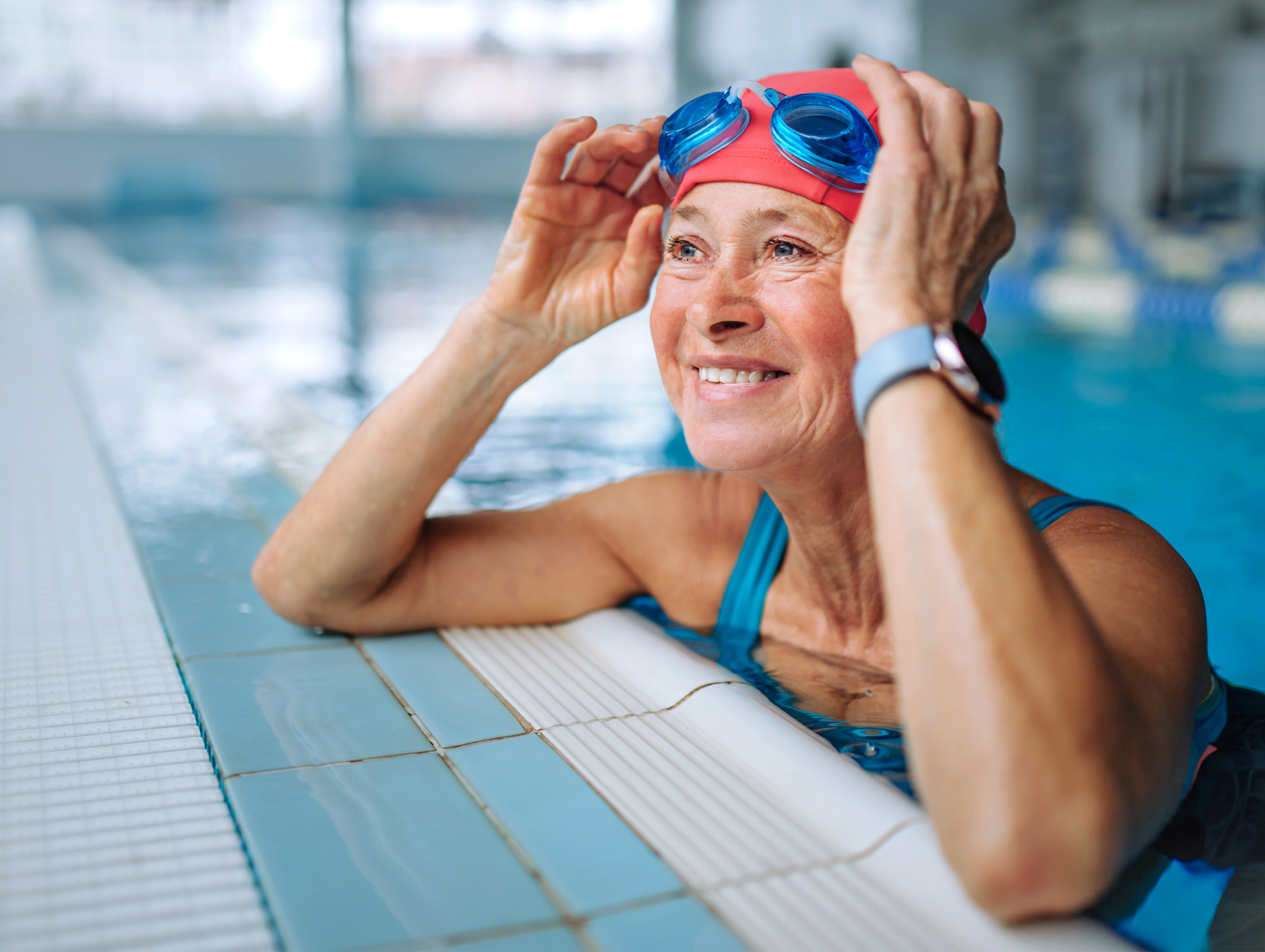 A senior woman smiling in a swimming pool