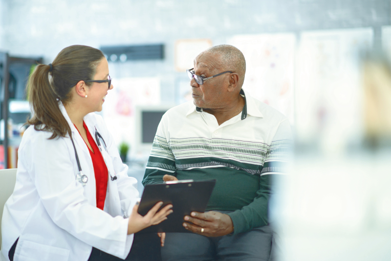 A senior man and doctor reviewing results in an office